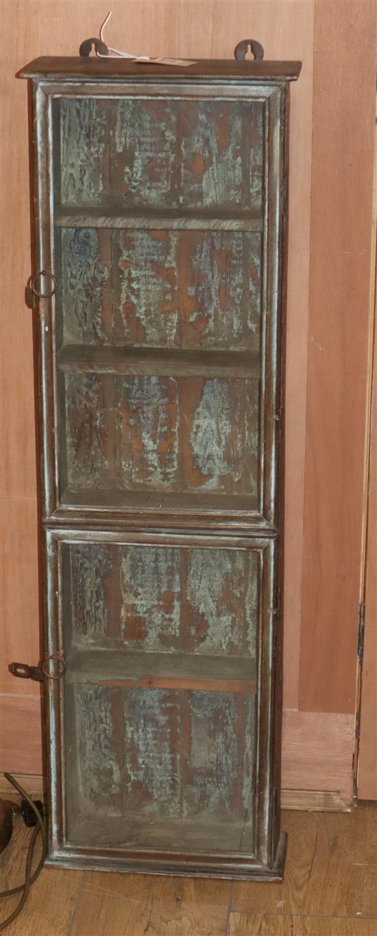 A distressed hardwood glazed wall cabinet